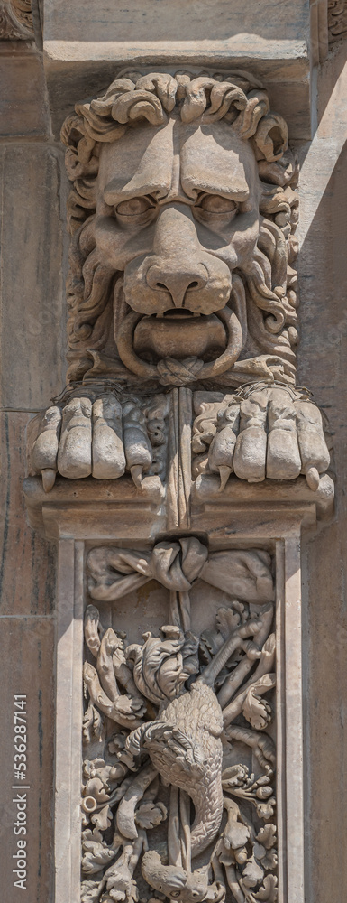 Scary lion head as decorative figure at facade of the Cathedral of Milano, Milan, Italy, closeup, details