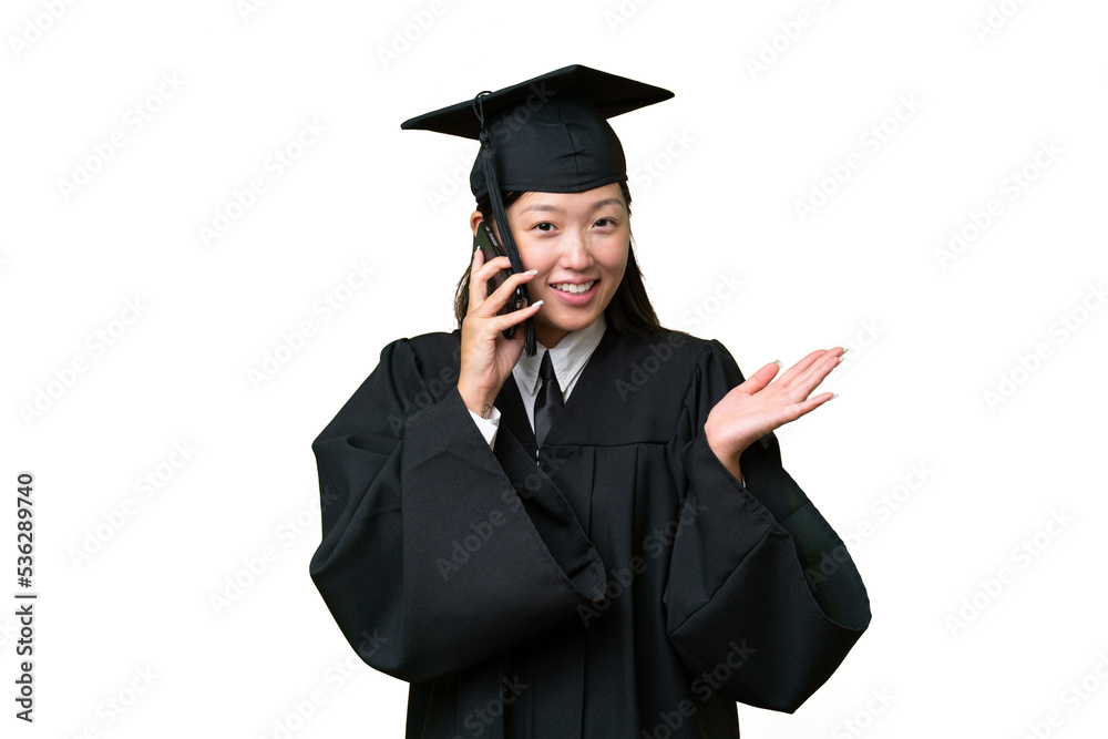 Young university graduate Asian woman over isolated background keeping a conversation with the mobile phone with someone Young university graduate Asian woman over isolated background keeping a conversation with the mobile phone with someone