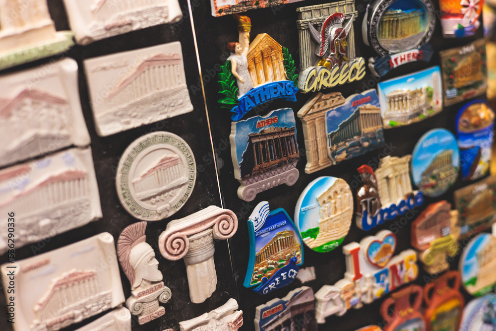 View of traditional tourist souvenirs and gifts from Athens, Attica, Greece with fridge magnets with text 