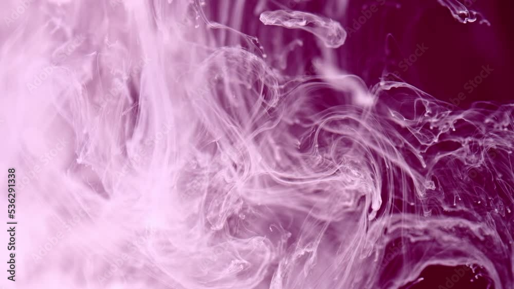 Abstract video with splash of white and pink paint in the water. Fluid textures of colored smoke in slow motion. Splashes of ink on purple background. Abstract video with splash of white and pink paint in the water. Fluid textures of colored smoke in slow motion. Splashes of ink on purple background.