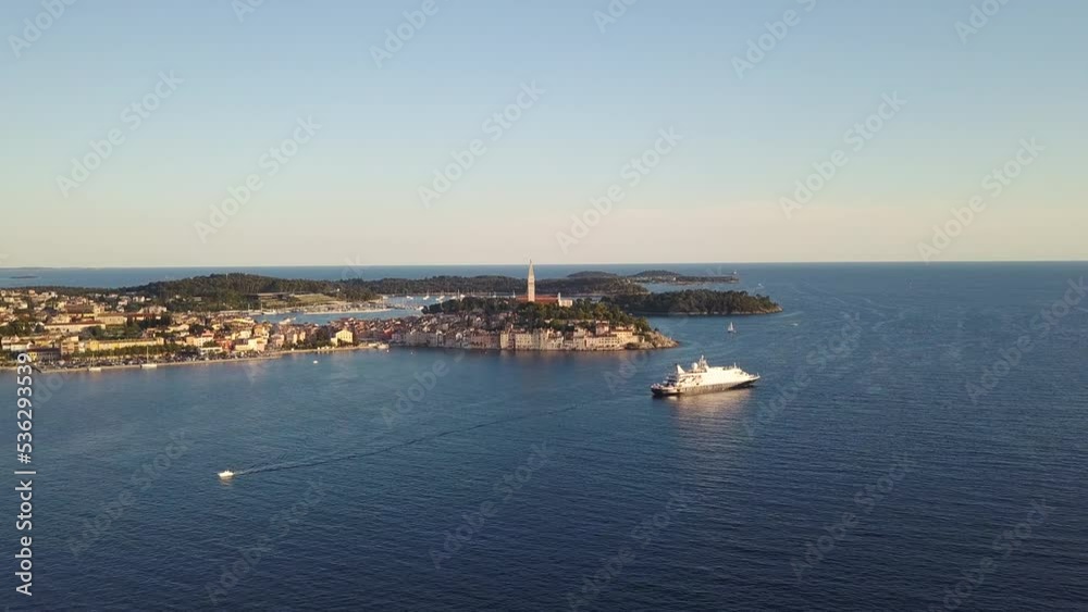 Beautiful Rovinj town (popular tourist resort and an active fishing port) at sunset. Aerial photo. The old town of Rovinj, Istria, Croatia. Beautiful Rovinj town (popular tourist resort and an active fishing port) at sunset. Aerial photo. The old town of Rovinj, Istria, Croatia.