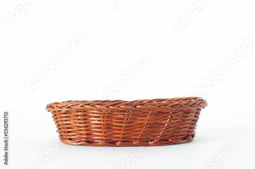 Empty, wooden and brown color weave wicker basket isolated on white background with selective focus.