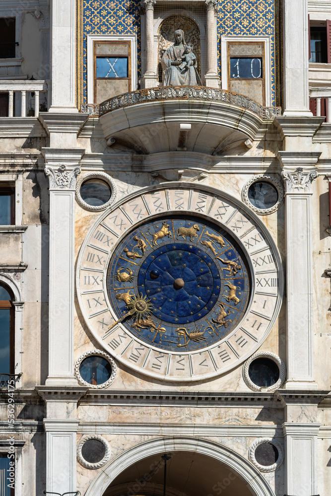 Saint Mark's Clock Tower in Saint Mark's Square (Piazza San Marco), Venice, vintage clock with golden zodiac signs and Roman dial, early Italian Renaissance architectural monument in Venice
