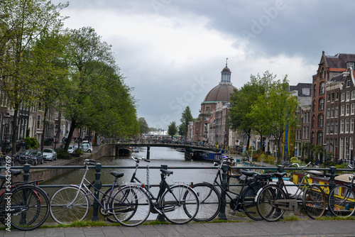 Bikes on a bridge over the canal in Amsterdam