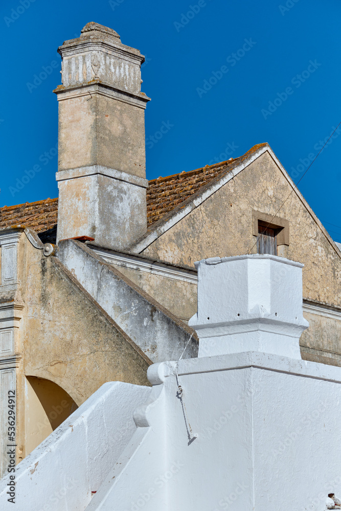 Traditional chimney on the roof of a houses in Olhao, Faro district, Algarve, Portugal