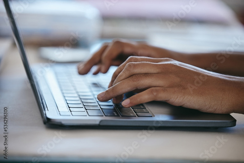 Hands typing, laptop and working freelance woman busy writing email or social media content while sitting at a table. Closeup of online planning, web search and internet browsing female using website