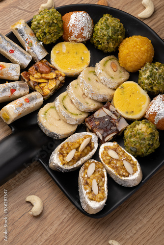 Group of Indian assorted sweets or mithai with diya