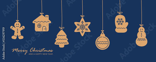 christmas card with hanging gingerbread cookies decoration on blue background