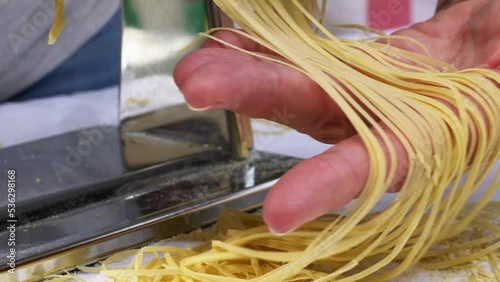 Making thin noodles for soup with rolling machine from special homemade dough