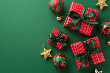 Christmas presents concept. Top view photo of gift boxes with ribbon bows red green gold baubles and star ornaments on isolated green background