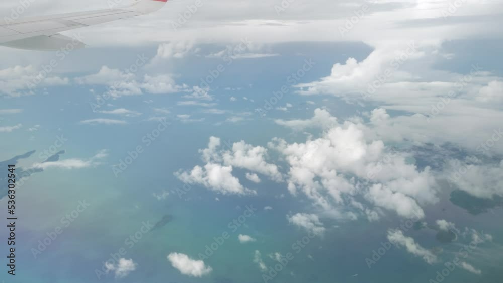 nature cloudscape above the cloud over sky with land from flying airplane in the clouds. The clouds are moving on camera. Flying through the cloud nature cloudscape above the cloud over sky with land from flying airplane in the clouds. The clouds are moving on camera. Flying through the cloud