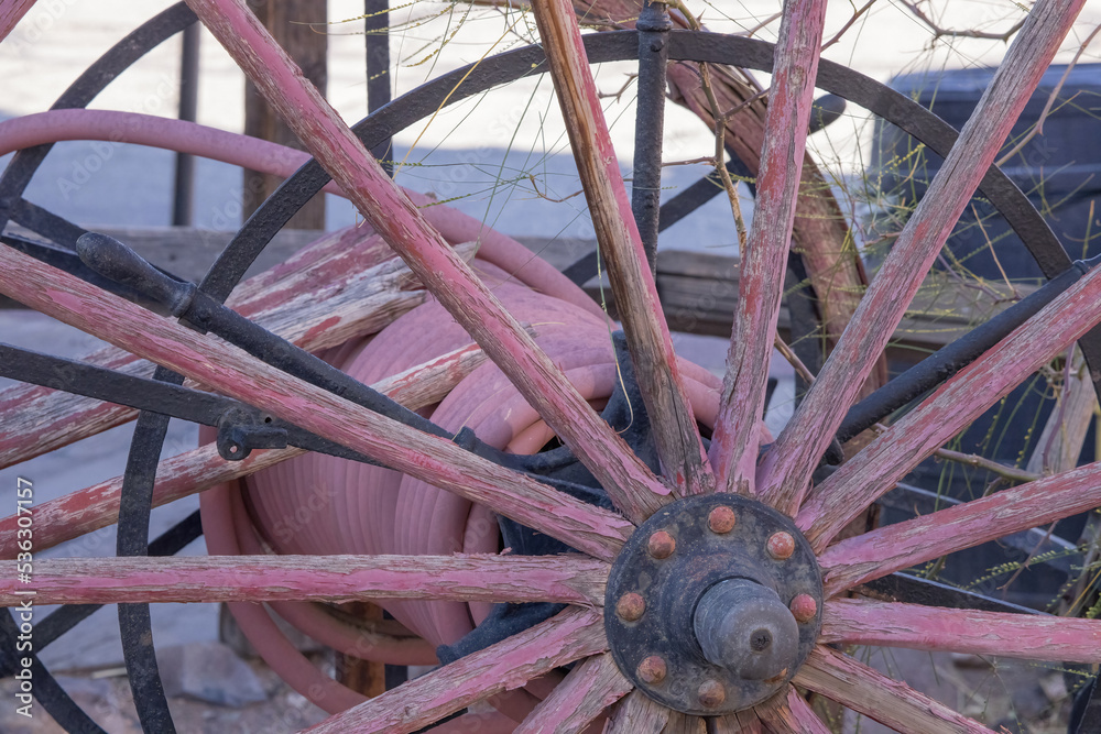 Old wooden wagon wheel with a metal hub