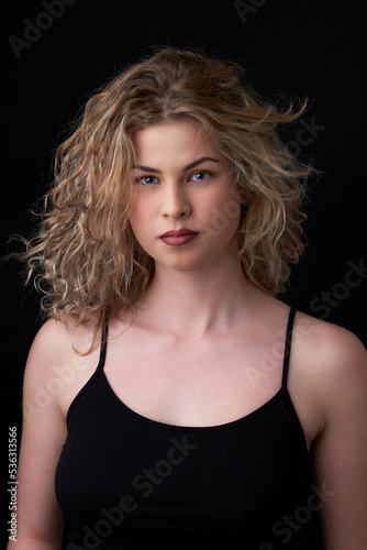young woman posing with black background