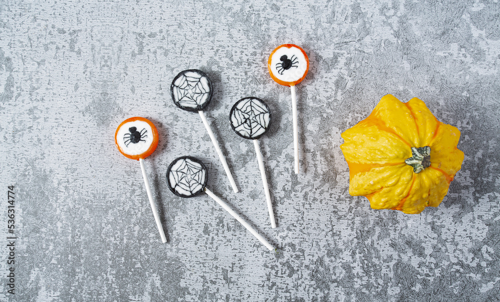Colorful halloween candies on grey stone surface Colorful halloween candies on grey stone surface
