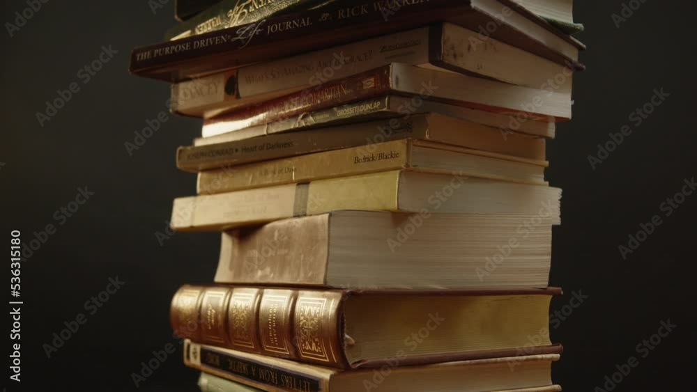 Pile of books spinning while the camera is tilting up