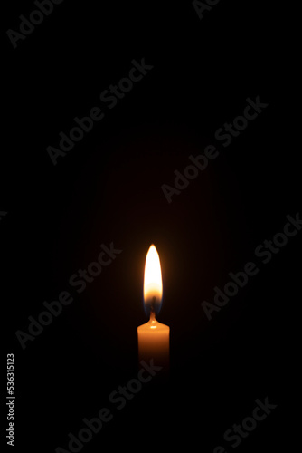 light of candle on black background