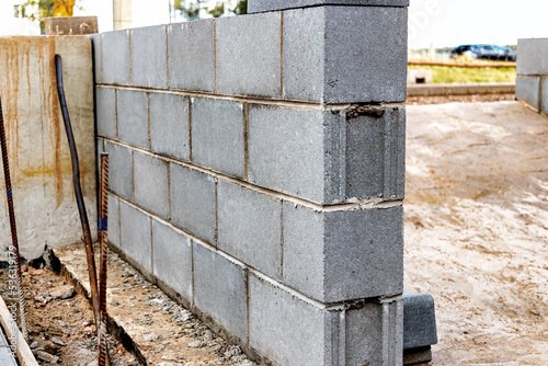 A wall of hollow concrete blocks at a construction site. The use of lightweight concrete blocks in construction.