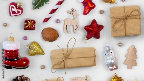 Moving Christmas decorations and gifts on bright background. Top view, flat lay, seamless looping. High quality 4k video.