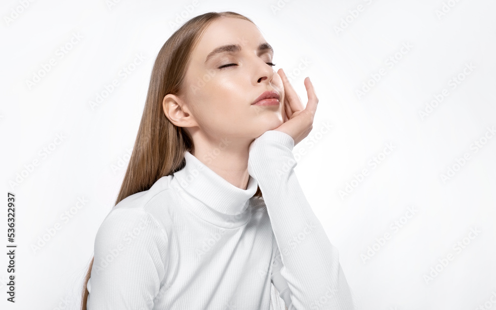 Woman with perfect skin and beautiful closes eyes in a white turtleneck on a white background. Woman with perfect skin and beautiful closes eyes in a white turtleneck on a white background.