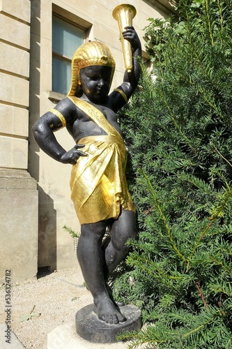 Egyptian style statue of a torch bearer or torchère at Cliveden House, Buckinghamshire photo