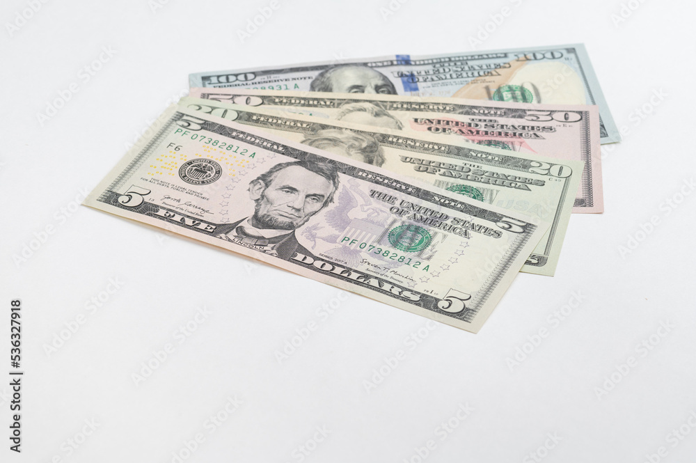 5, 20, 50, 100 dollars banknotes at different angles. Close up of dollars on white background. 5, 20, 50, 100 dollars banknotes at different angles. Close up of dollars on white background.