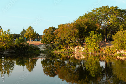 Landscape photo of the city park and lake in the Fall with beautiful reflection.