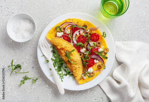 omelette with tomato, feta cheese onion and arugula. healthy keto diet low carb breakfast