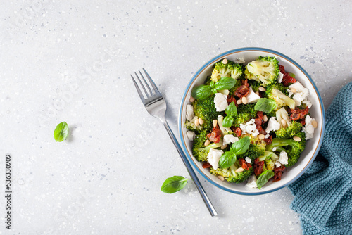 Obraz na plátně healthy broccoli salad with feta cheese sun dried tomatoes pine nuts