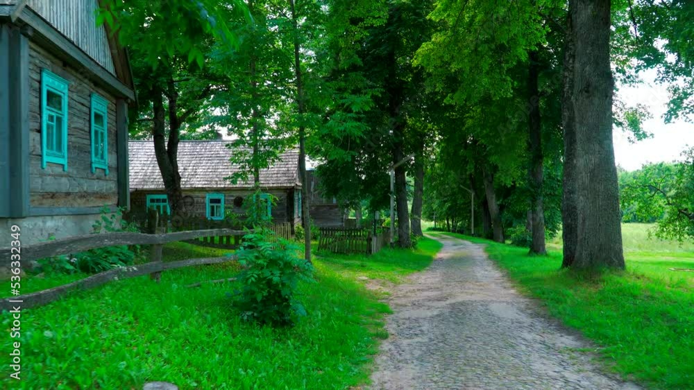 Old village road, paved with old lime trees and wooden houses. Old village road, paved with old lime trees and wooden houses.