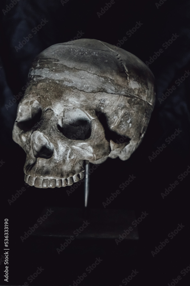 Obraz premium Human skull made of concrete on a stand. Interior decor.
