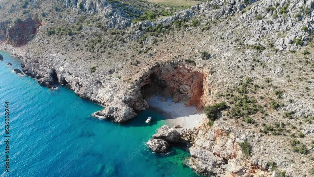 Travel and beach holiday concept. Aerial view of the secluded Beach at the rough and cliffy coast Travel and beach holiday concept. Aerial view of the secluded Beach at the rough and cliffy coast