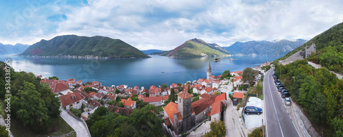 Aerial  view of the historic town of Perast at Bay of Kotor. View over roofs to the campanile of the Church of St. Nicholas and  islands St. George and Our Lady of the Rocks. Perast, Montenegro