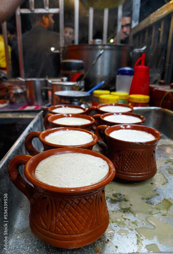 Traditional indian tea set or for serving black tea. Consists of a pot, cups, and a tray made of clay. Isolated, copy space. Traditional indian tea set or for serving black tea. Consists of a pot, cups, and a tray made of clay. Isolated, copy space.