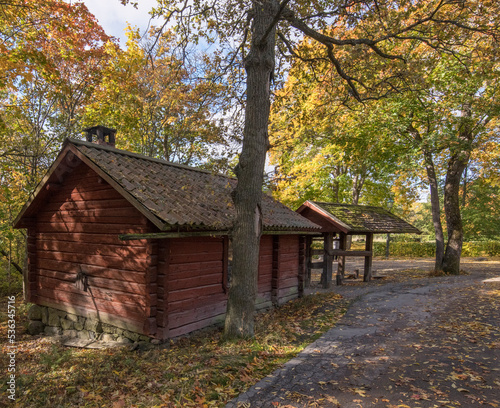 Old wood 1700s smithers house in a park a colorful sunny autumn day in Stockholm