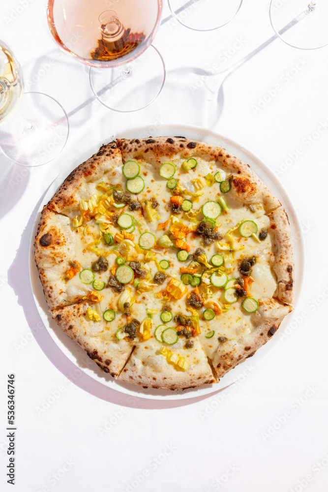 Pizza with zucchini and glasses of wine Pizza with zucchini and glasses of wine