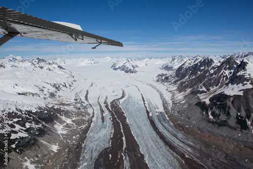 Airplane wing and mountain landscape in Glacier Bay National Park photo