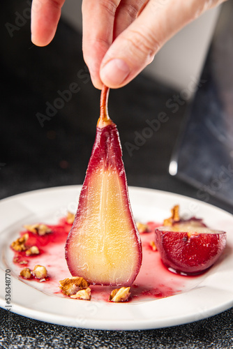 pear in red wine sweet dessert french cuisine healthy meal food snack diet on the table copy space food background rustic top view