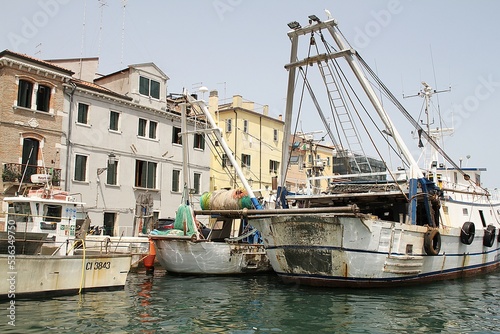 fishing boats, large boats moored in the canal between houses, Italian city of Chioggia, fishing equipment, fishing machinery