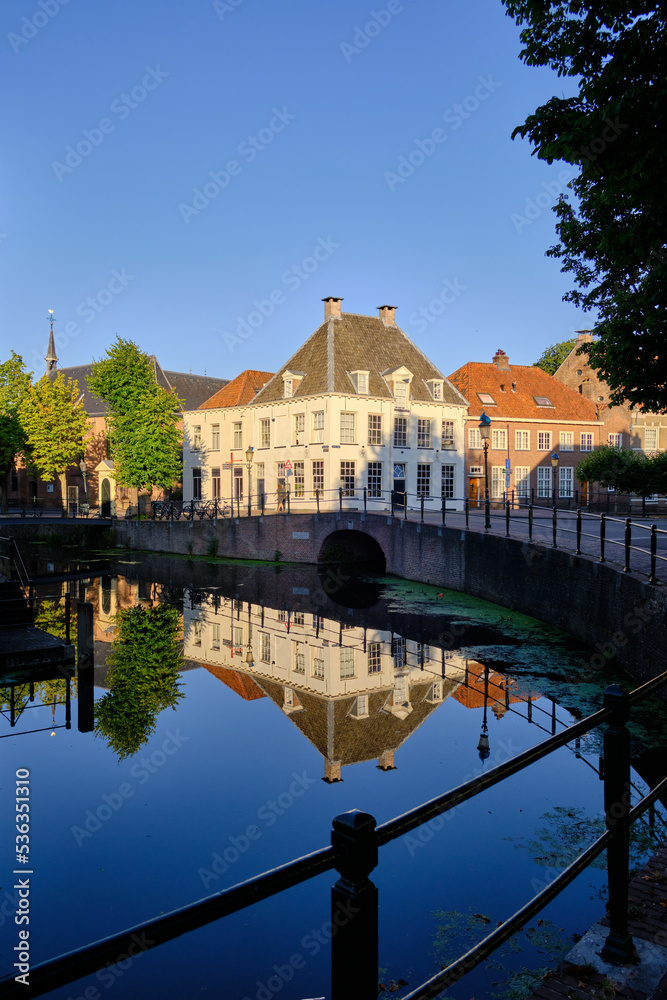 Amersfoort, Netherlands - August 09, 2022: Canal house reflections in the Westsingel canal in the historic centre of Amersfoort.