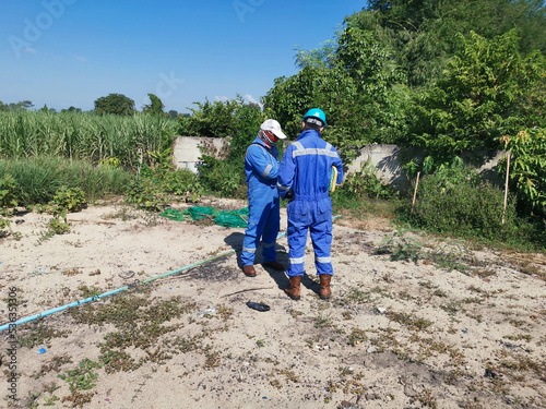 A radiation safety officer (RSO) inspecting radiation dose rate in a farming area around a drilling site
