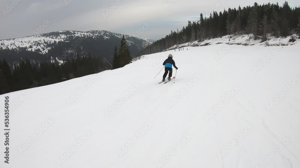 Skier skiing downhill in high mountains, point of view. Winter sport and recreation, leisure outdoor activities Skier skiing downhill in high mountains, point of view. Winter sport and recreation, leisure outdoor activities