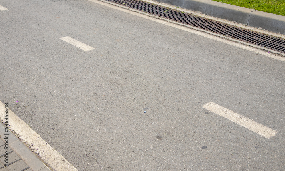 An intermittent lane marking line and the direction of traffic on an asphalt road with a copy of the space An intermittent lane marking line and the direction of traffic on an asphalt road with a copy of the space