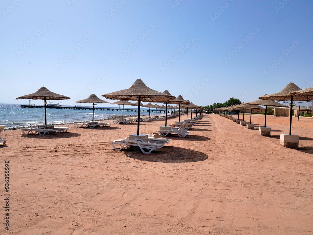 beach with awnings for shade and sun loungers
