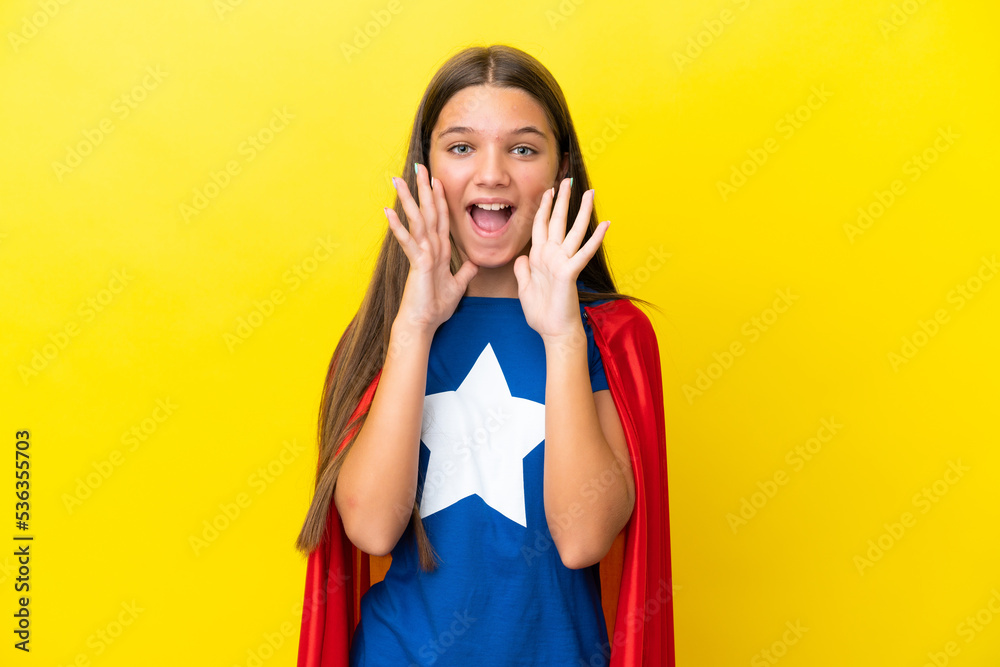 Little caucasian superhero girl isolated on yellow background shouting and announcing something Little caucasian superhero girl isolated on yellow background shouting and announcing something