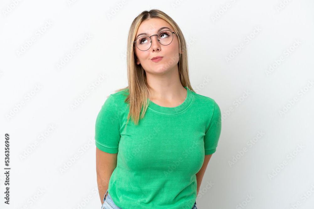 Young caucasian woman isolated on white background and looking up Young caucasian woman isolated on white background and looking up