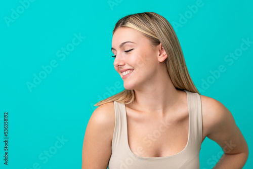 Portrait of pretty young woman over blue isolated background