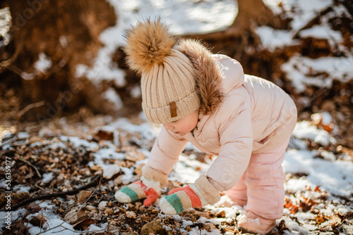 Young female child in winter playing outdoors in the snow bundle photo