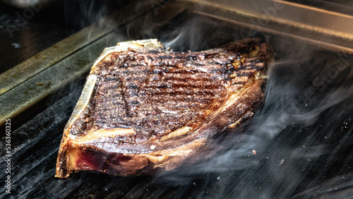 cote de bœuf sur une plancha en cuisson photo