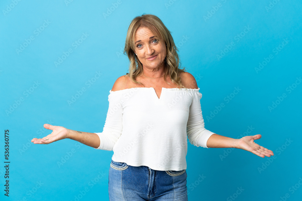 Middle aged blonde woman over isolated background having doubts Middle aged blonde woman over isolated background having doubts