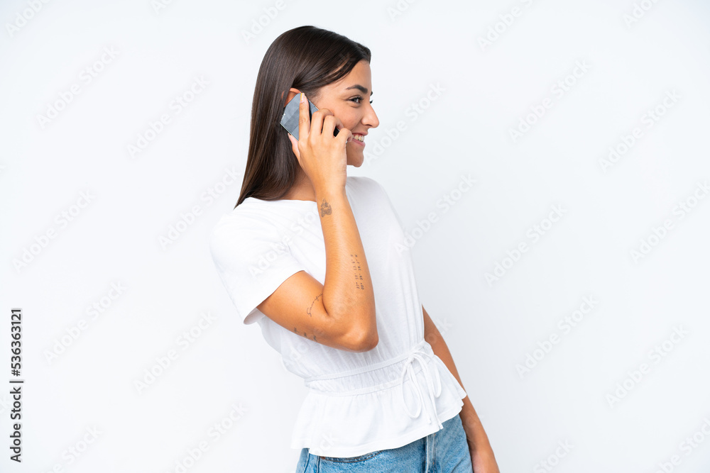 Young caucasian woman isolated on white background keeping a conversation with the mobile phone with someone Young caucasian woman isolated on white background keeping a conversation with the mobile phone with someone